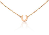 Rose gold vermeil mini horseshoe necklace on an adjustable chain, presented against a white background.